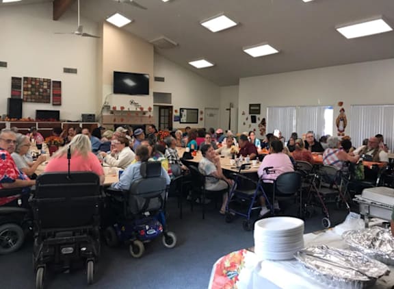 a large group of people sitting at tables in a room