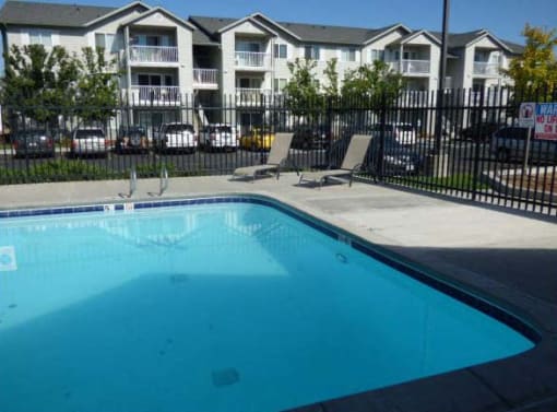 Heron Creek Apartments l pool with lounge chairs
