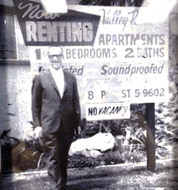 a man standing in front of a sign