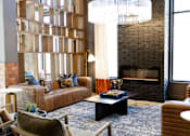 Thumbnail 1 of 9 - A modern living room with a fireplace and a large window. at District on the Etowah Apartments, Canton, 30114