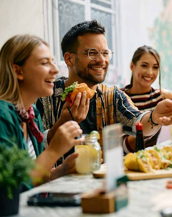 A group of people enjoying a meal together at a table.