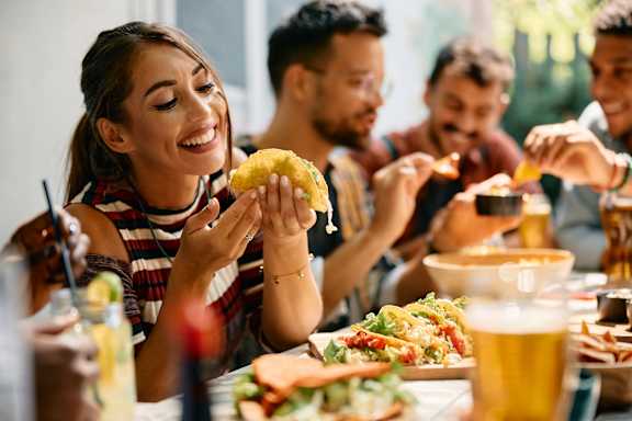 A group of people enjoying a meal together at a restaurant.