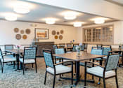 Thumbnail 3 of 5 - a dining room with tables and chairs and a fireplace