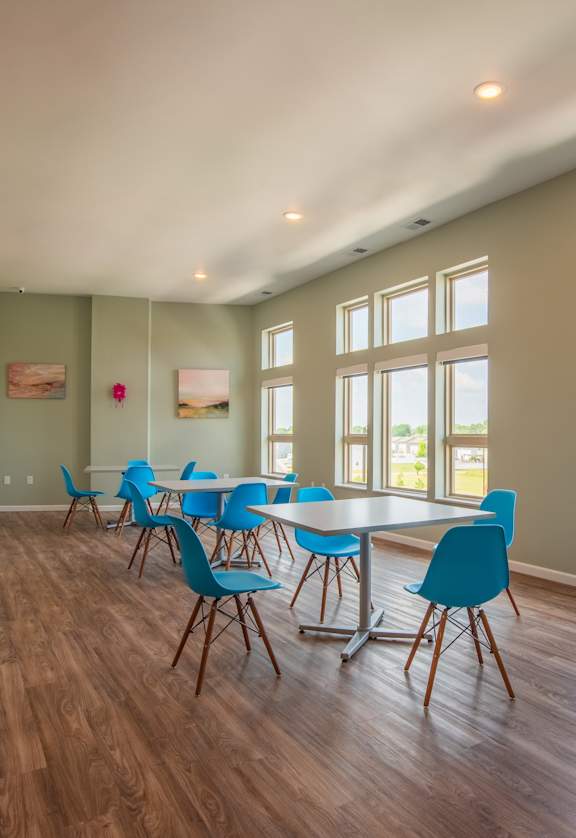 A room with a long table and chairs.