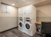 Thumbnail 6 of 7 - A washing machine repair shop with a sign on the wall.