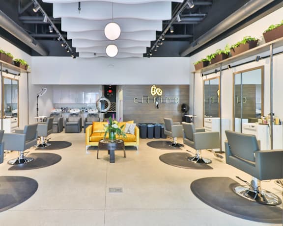 a large lobby with chairs and tables and a reception desk