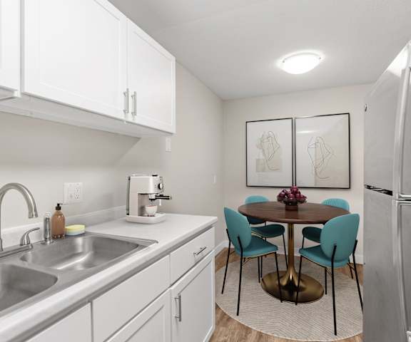 A kitchen with a table and chairs.