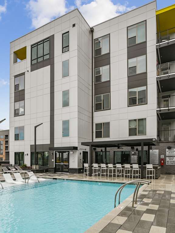 a swimming pool in front of a building  at Link Apartments® Mint Street, Charlotte, North Carolina