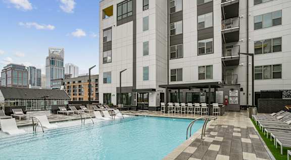 a swimming pool in front of a building  at Link Apartments® Mint Street, Charlotte, North Carolina