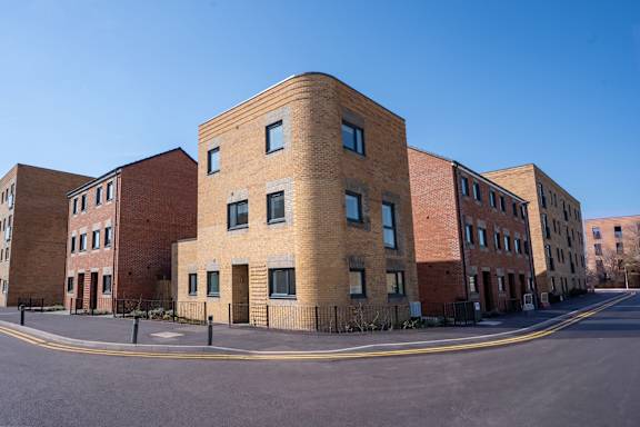 A large brick building with a curved corner.