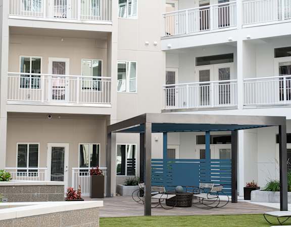 A white building with blue trim and a balcony.