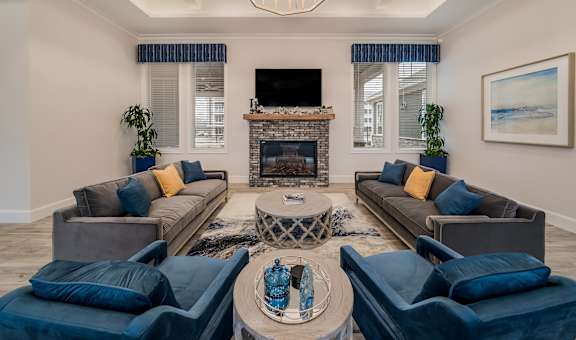 a living room with couches and chairs and a fireplace