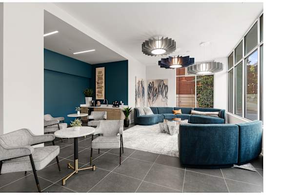 A modern living room with a dining table and grey chairs.