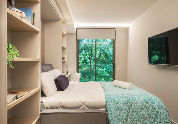 a bedroom with a bed and a window