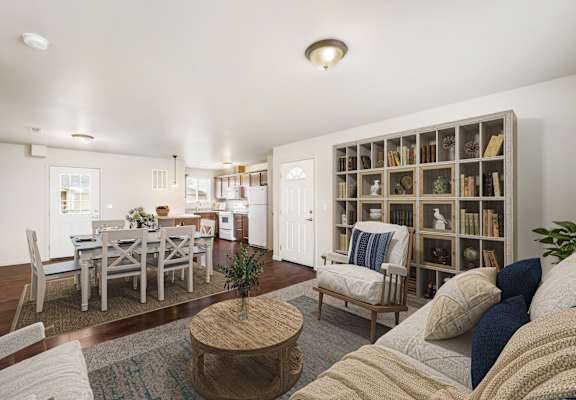 a living room with a couch and a table and a bookcase at Pine Tree Park, Kennewick