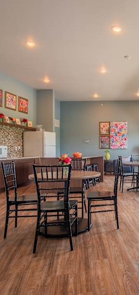 A dining room with a table set for six.