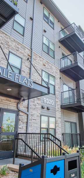 A modern apartment complex named Lyndale Flats with a playground in front.