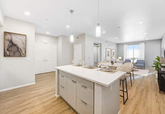 A modern kitchen with a large island and bar stools.
