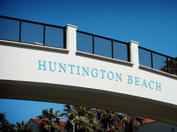 A man and a woman are walking on the beach.