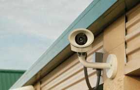 A security camera is mounted on a building.