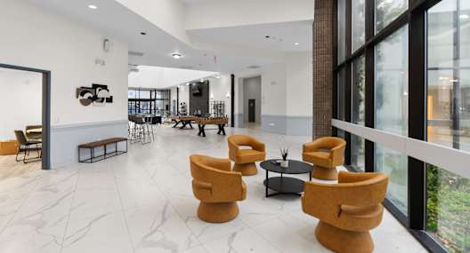 A modern living room with a white marble floor and a large window.