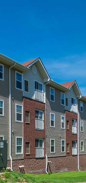Apartment building with a green lawn in front.