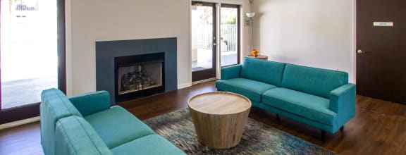 a clubhouse with two blue couches and a coffee table
