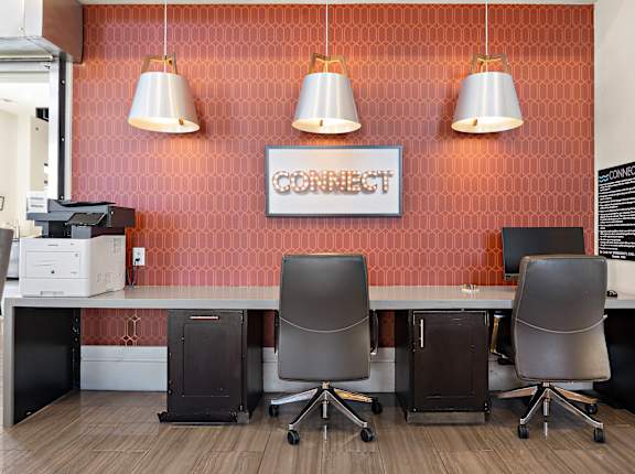 a conference room with four chairs and a table in front of a wall with a at North Creek, Hutto, 78634