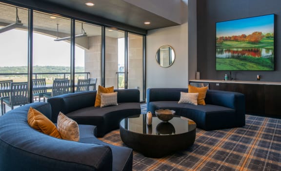 a living room with couches and a coffee table and a television at The Apex at CityPlace, Overland Park, 66210