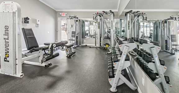 A gym with a variety of equipment including a leg press machine.