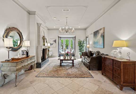 a living room filled with furniture and a chandelier