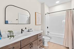 A bathroom with a white sink and a white toilet.