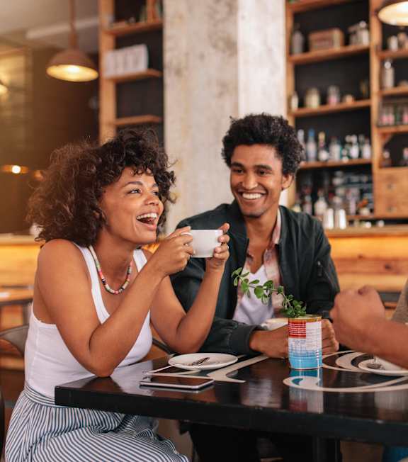 Four people are sitting at a table in a restaurant at The Oliver Apartments, Olivette, MO, 63132