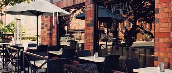 a restaurant with tables and chairs and an umbrella at The Enclave, Jersey City, New Jersey