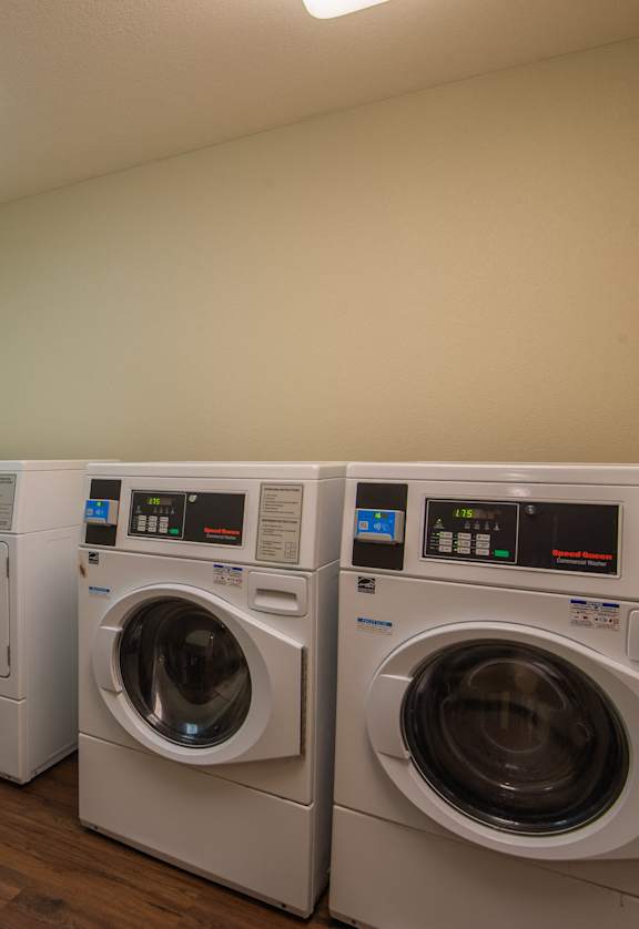 a washer and dryer in a laundry room with a window and two was