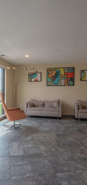 a living room with couches and chairs and a large window