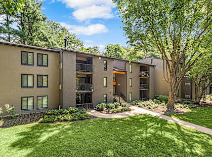 A building with a green lawn in front of it.