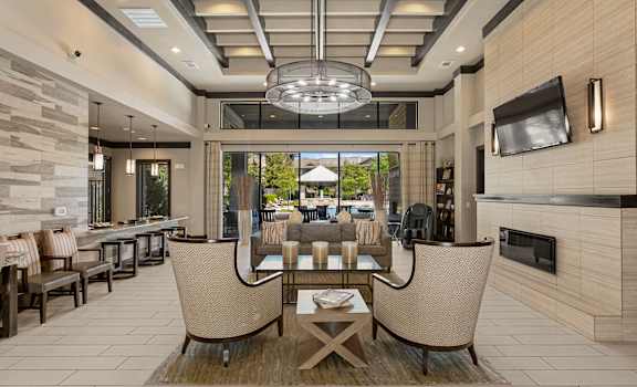 A modern outdoor patio with a table and chairs.