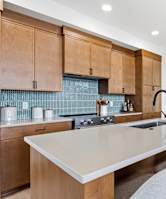 A kitchen with wooden cabinets and a white countertop.