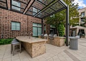 Thumbnail 28 of 33 - a patio with a hot tub and a grill