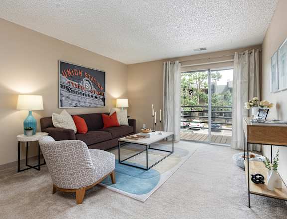 A living room with a couch, chair, and coffee table.