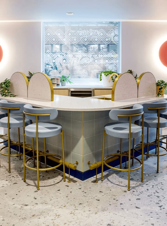 a bar with chairs and a sink in a kitchen