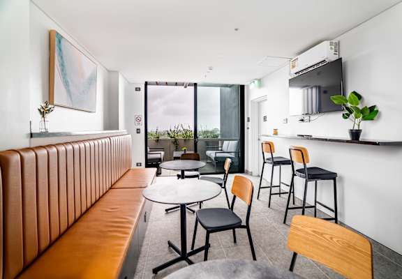 a dining room with tables and chairs and a bar