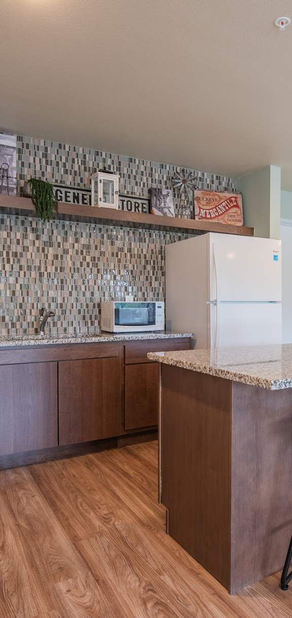 A kitchen with a bar and stools.