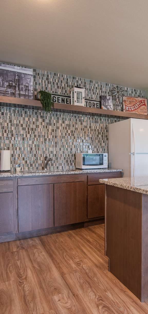 A kitchen with a bar and stools.