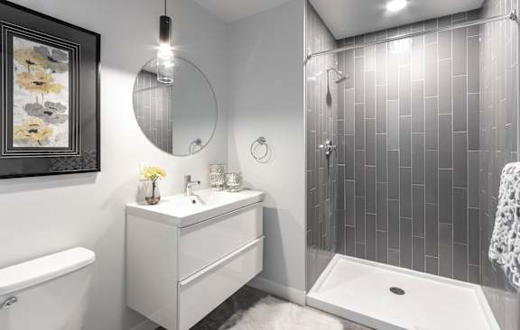 A bathroom with a white sink and a white tub.