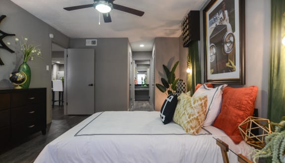 a bedroom with a large bed and a ceiling fan