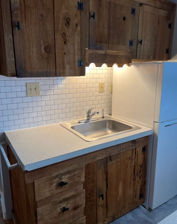 a kitchen with a sink and a refrigerator