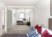 Thumbnail 10 of 12 - a bedroom with a bed and a mirror