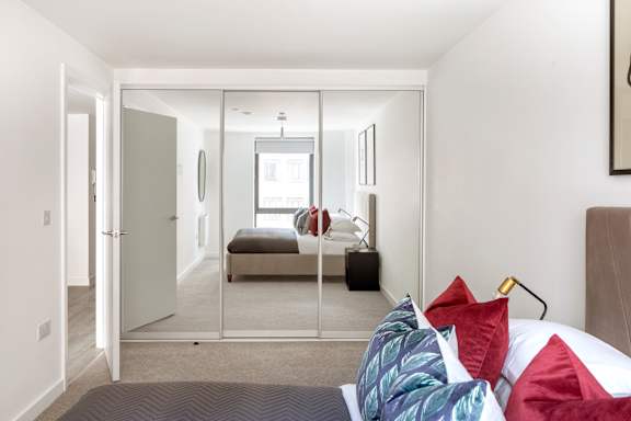 a bedroom with a bed and a mirror